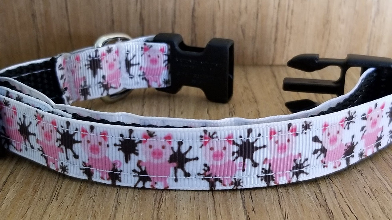 A pink white and black Leash/ Small/ Pigs in the Mud shown has little pink pigs decorating it