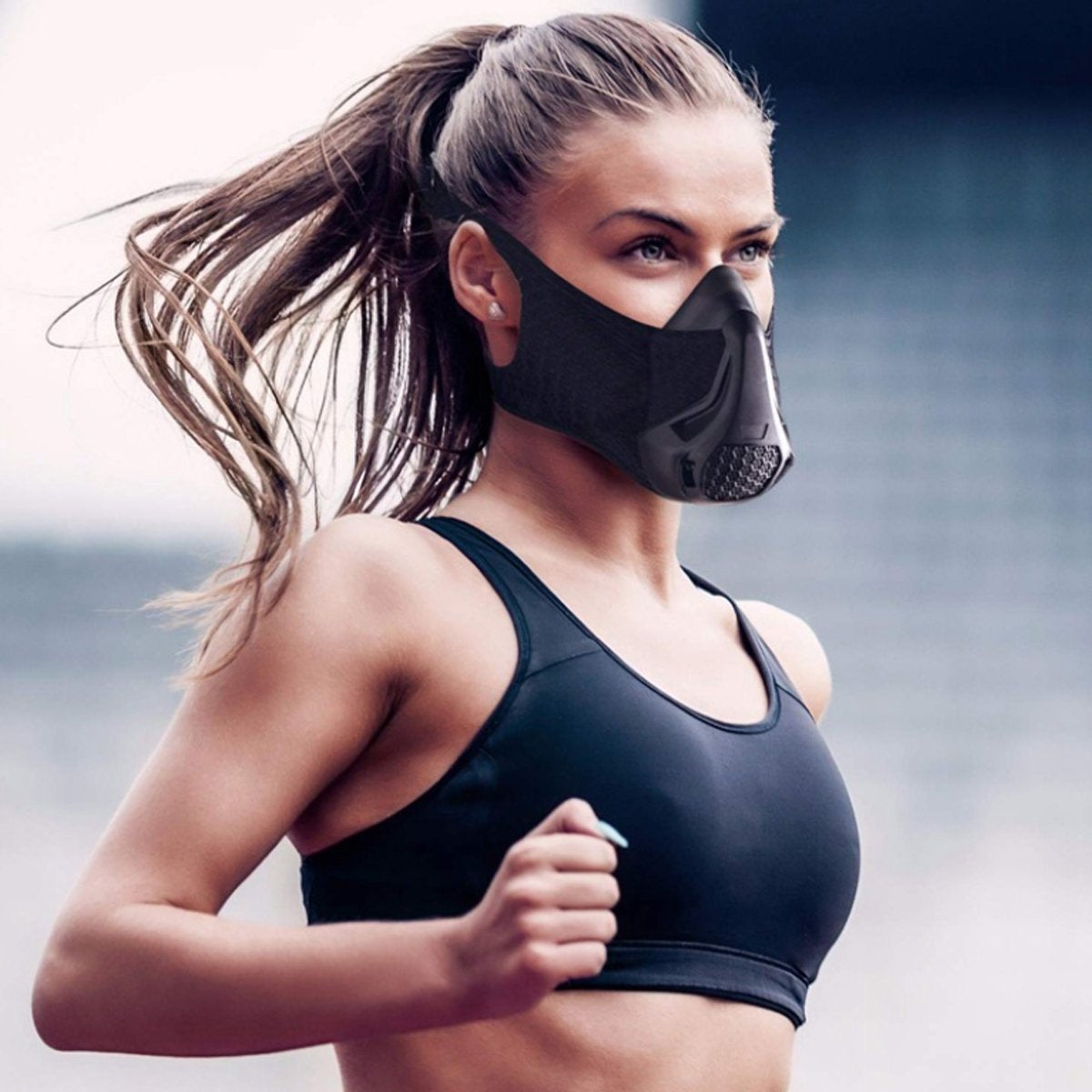 A female model jogging wearing the black Premium Cardio Workout Sports Mask