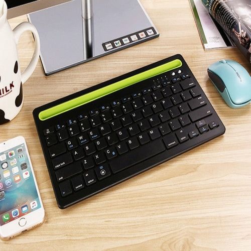 A Multi-Task Master Of All Bluetooth Keyboard shown in black with lime green tablet and phone holder nook area