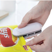 Thumbnail for Shows the Snack Bag Open And Seal Mini Machine 2 In 1 being used to seal a bag of potato chips