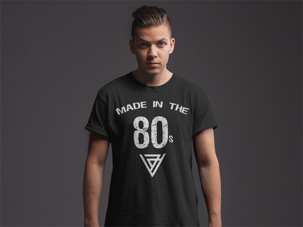 A black In the 80's T-shirt shown worn by a male model shirt is black with the words Made in the 80s shown in white