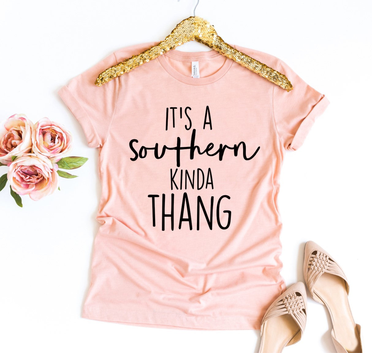 A peach It's A Southern Kinda Thang T-shirt shown with roses next to it and a peach pair of heels