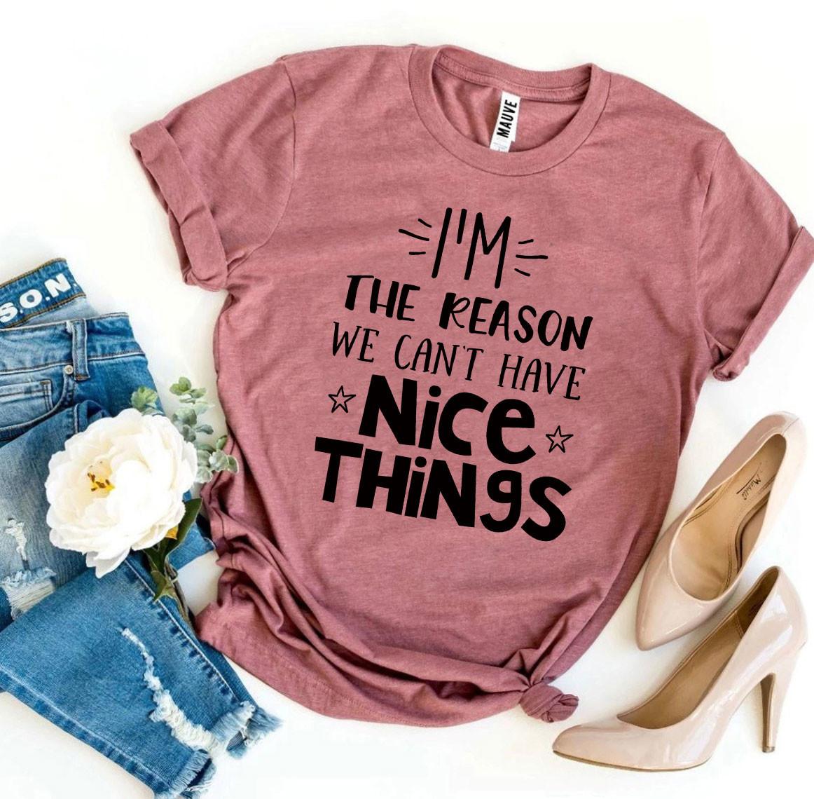 A pink I’m The Reason We Can’t Have Nice Things T-shirt with a pair of jeans next to it and a pair of tan heels