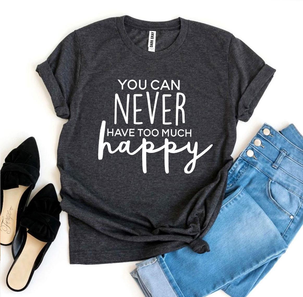 A black and white You Can Never Have Too Much Happy T-shirt shown with a pair of black heels and blue jeans sitting next to it