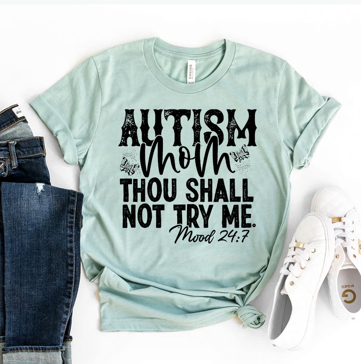 Autism Mom T-shirt shown with the words Autism Mom thou Shall not try me mood 24:7 in teal green