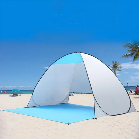 An Automatic Easy Outdoor Tent shown sitting on the beach in blue and white