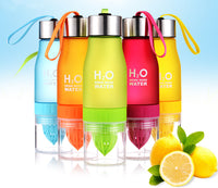 Thumbnail for Several 20 oz fruit infuser bottles shown in various colors blue orange green red yellow with a fresh cut lemon sitting near on a table