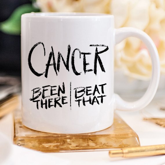 A Cancer Survivor Been There Gift Mug sitting on a wooden boho cup holder sitting on a table