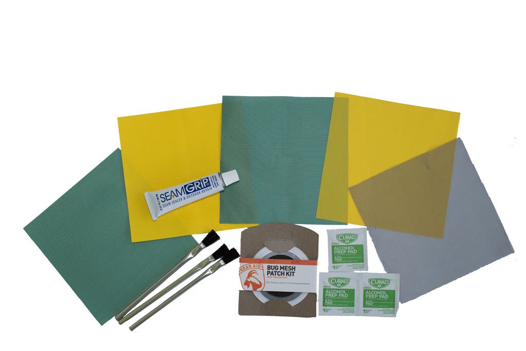 A Mons Peak IX Night Sky Home & Field Repair Kit shown Green and yellow tent fabric patches with seam grip sealer 3 glue application brushes and 3 alcohol prep pads