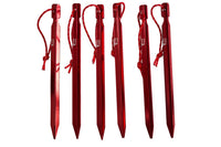 Thumbnail for Shows a set of Mons Peak IX Tent Stakes, (6 Pack) they are a metallic red in color with white writing on them